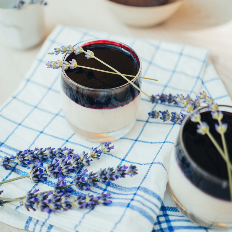 Pannacotta in a glass with purple covering and lavender decorations