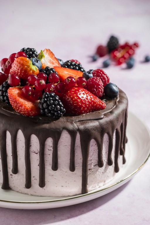 Vegan Cake with chocolate cover and fresh fruit on top
