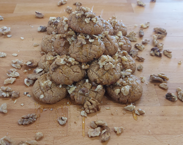 Melomakarona - traditional Greek Christmas honey cookies soaked in syrup and topped with walnuts. — 